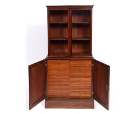 A Victorian collector's mahogany cabinet, having a pair of glazed doors above a pair of panel doors enclosing two rows of 23 