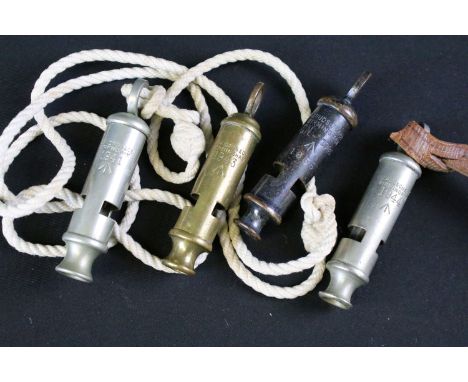 A collection of four British military issued pocket whistles to include World War Two / WW2 examples, all marked with the Bri