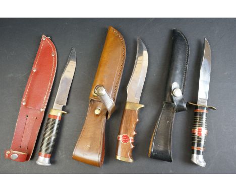 A collection of three William Rogers of Sheffield, British made scouting / hunting knives, all complete with leather sheaths.
