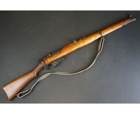 A Lee-Enfield (SMLE) .303 bolt-action service rifle with adjustable sights, storage compartment to the brass butt plate, fram