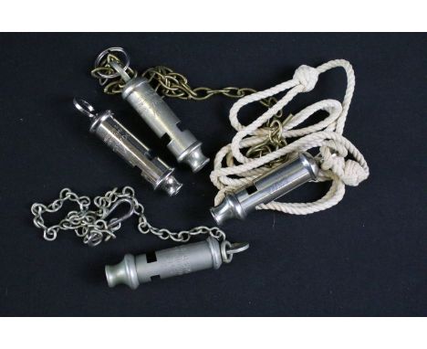 A collection of four British military issued pocket whistles to include World War Two / WW2 examples, all marked with the Bri