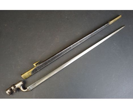A British 1876 pattern 'Martini Henry' socket bayonet, WD mark with broad arrow to blade and scabbard, with leather scabbard 