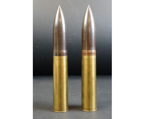 Two British mililtary inert artillery shells, both dated 1916, 2 pounders, broad arrow marked.
