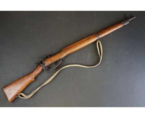 A Lee-Enfield (SMLE) No.4 MK.II (F) .303 bolt-action service rifle with adjustable sights, storage compartment to the brass b