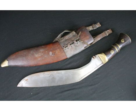 A World War Two era large Kukri knife, steel blade, wooden handle with brass fixings, broad arrow mark to the blade, blade me