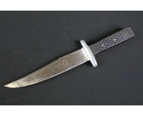 A vintage mid 20th century hunting sheath knife, steel single sided blade stamped made in Sheffield England, two piece rivete