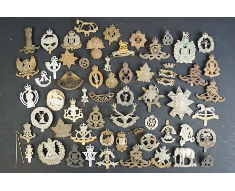 A collection of approx fifty mainly British military regimental cap and collar badges to include the Tank Regiment, Suffolk R