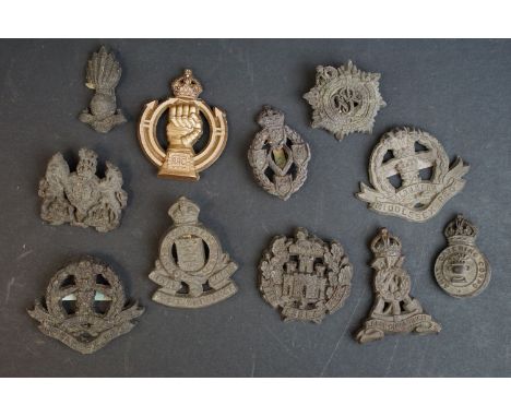 A collection of eleven British World War Two / WW2 plastic economy cap and collar badges to include the Middlesex Regiment, L