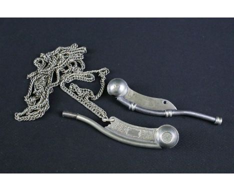 Two British Royal Navy issued Bosun's whistles, both marked with the British broad arrow mark.