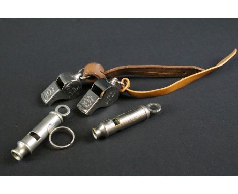 A collection of four British military issued pocket whistles to include World War Two / WW2 examples, all marked with the Bri
