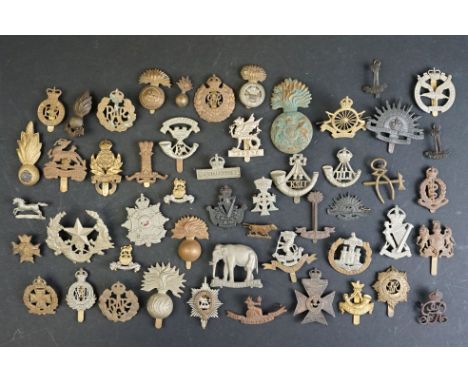 A collection of approx fifty mainly British military regimental cap and collar badges to include the Royal Army Service Corps