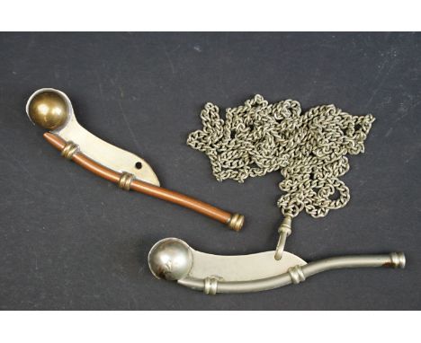 A British Royal Navy issued bosun's whistle with broad arrow mark together with a copper and brass example. 