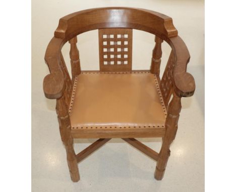 Mouseman: A Robert Thompson of Kilburn English Oak Monk's Chair, with curved back and shaped arms, over three lattice panels,