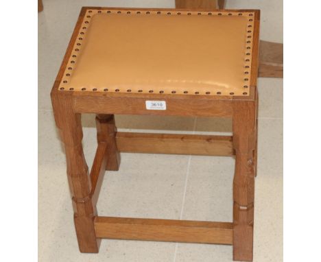 Mouseman: A Robert Thompson of Kilburn English Oak Dressing Table Stool, with upholstered cow hide seat, on four octagonal le