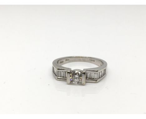 A Modern design 18 carat white gold ring with central brilliant cut diamond 0.40 carat  colour grade F/G clarity Sl. The cent