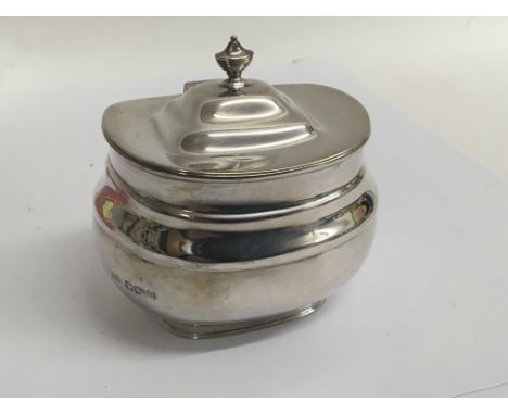 A Silver tea caddy with a hinged oval lid Sheffield hallmarks for 1912.