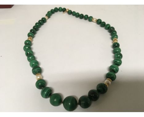 A Malachite graduating bead necklace with cultured pearls and 14carat Gold ring dividers.