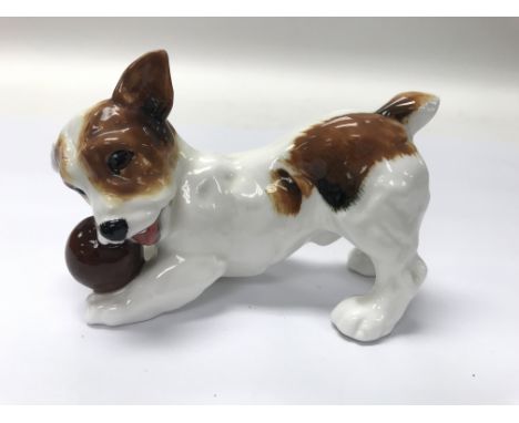 A Doulton dog playing with a ball.