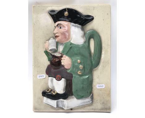 A raised relief tile Toby jug wall plaque. Size approx 33.5x24.5cm.