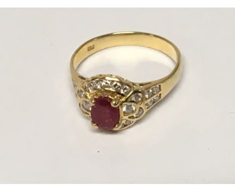 An 18carat Gold ruby and diamond ring the central ruby flanked by diamonds.ring size S.