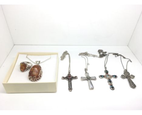 A silver and amber pendant necklace and conforming ring plus four silver crosses