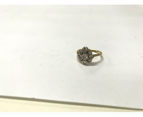 An 18ct yellow gold ring set with graduating diamonds set in a cluster. Weight approx 3g, size approx K.