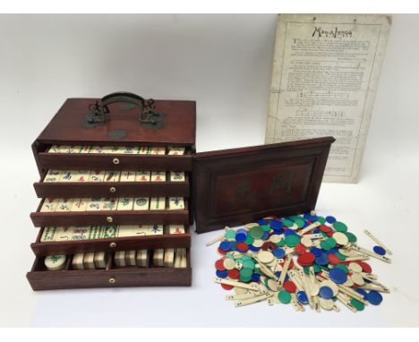 A cased Mahjong set with additional counters and rule sheet.