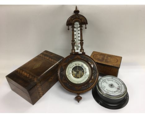 A circular barometer plus a carved walnut example, a tunbridge ware style box plus a smaller example of with quarter veneer t