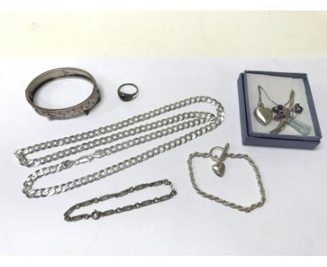 A collection of silver jewellery including necklaces, bracelets, a ring and a bracelet.
