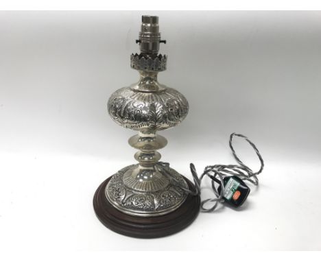 An Indian white metal lamp.