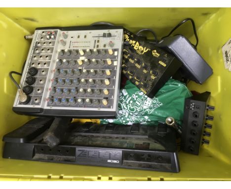 A crate containing musical recording equipment including a Boss BR8 digital recording studio, a Zoom 3030 guitar effects peda