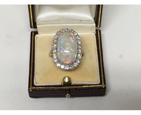 A fine gold ring set with a large solid opal 10 ct approx surrounded by brilliant cut diamonds 1.8 ct approx.size M