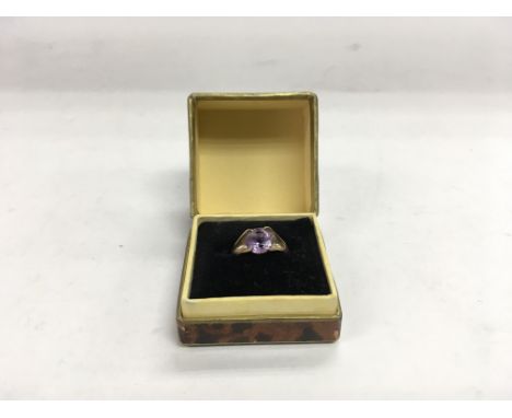 A 9ct gold purple stone ring