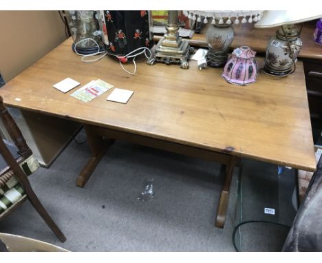 A pine Ercol dining table and four chairs.