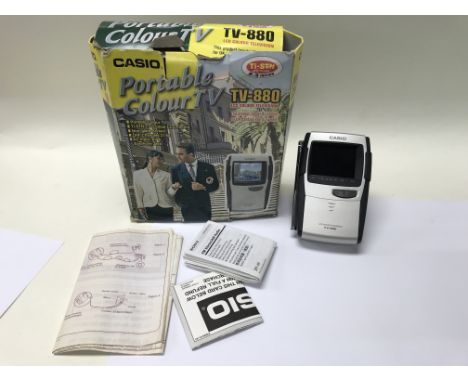 A JVC portable television, model CX-610GB in plastic case together with a boxed Casio portable TV, model TV-880.