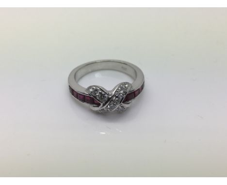 An 18ct gold, diamond and ruby ring of modern crossover design, approx 5g and approx size K-L.