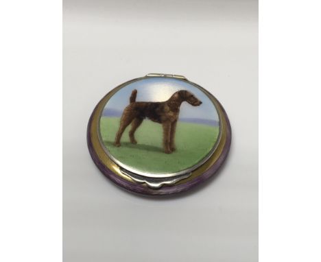 A fine silver and enamel compact the centre with a terrier dog