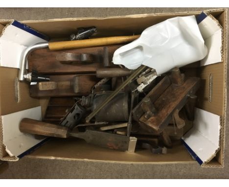 A box containing woodworking planes and other tools