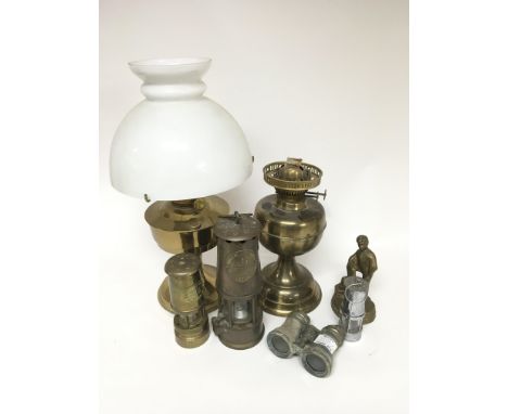 An Eccles 'Protector' lamp, a smaller lamp of similar type, two brass oil lamps, a small pair of binoculars, possibly from th