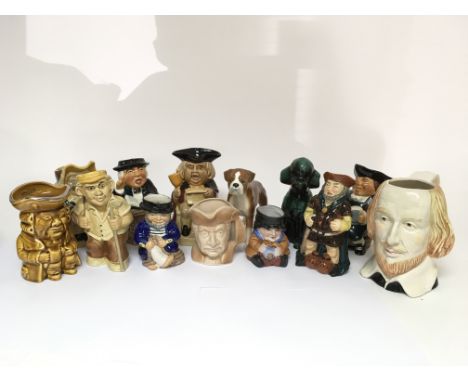 A collection of eleven ceramic caricature drinking vessels and two ceramic dogs, including a boxer.