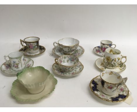 A collection of eight decorative painted cabinet cups and saucers including Coalport and Limoges