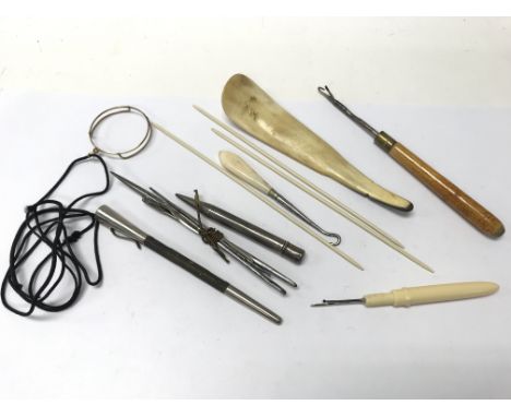 A collection of sewing tools, a monocle and a silver pencil.