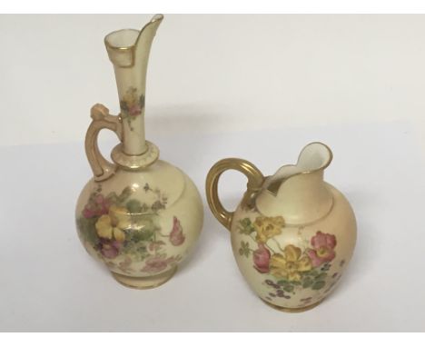 Two hand painted Worcester jugs decorated with flowers and foliage.