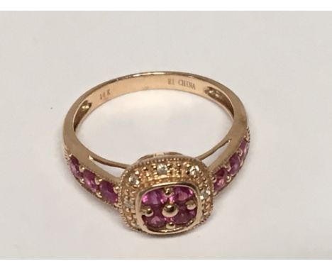 A 14carat Rosegold ring set with diamonds and pink Sapphires. Ring size L.