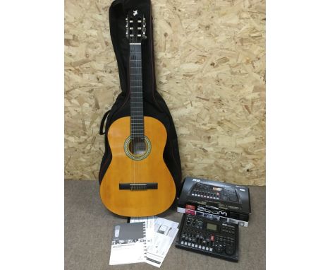 A boxed Zoom R8 recording interface controller and sampler plus a classical guitar in a soft carry case (2).