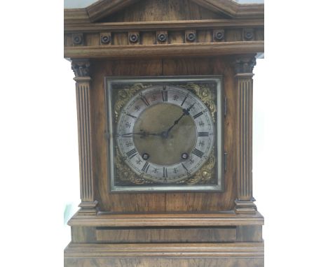 An Edwardian walnut mantle clock the silver chapter ring with Roman numerals