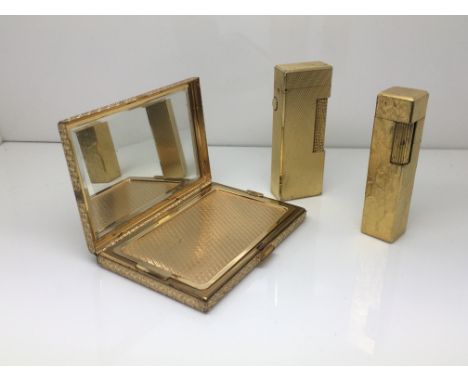 A gilt compact and two cigarette lighters comprising a Dunhill example and one other (3).