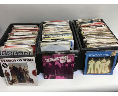 Three boxes of 7 inch singles by various artists including The Rolling Stones, The Jam, Slade and others.