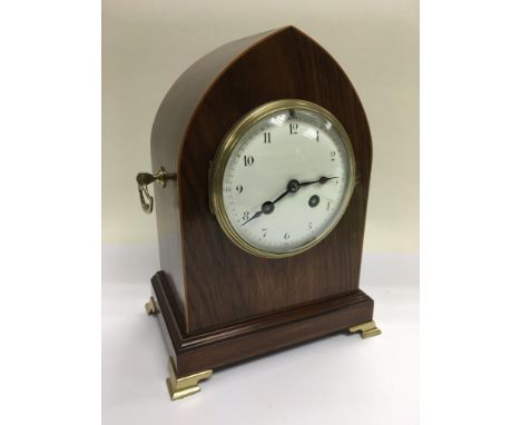 A French rosewood eight day mantle clock with arched top, approx 25.5cm. Comes with pendulum and key.