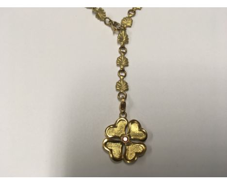An 18 carat Gold necklace with acanthus leave shaped links the pendent set with a small ruby weight24g appropriately.